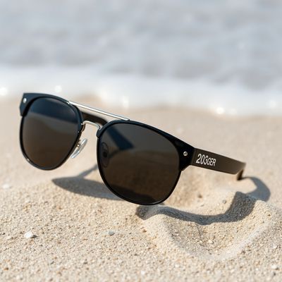AI product photo of designer sunglasses resting on sand with ocean background